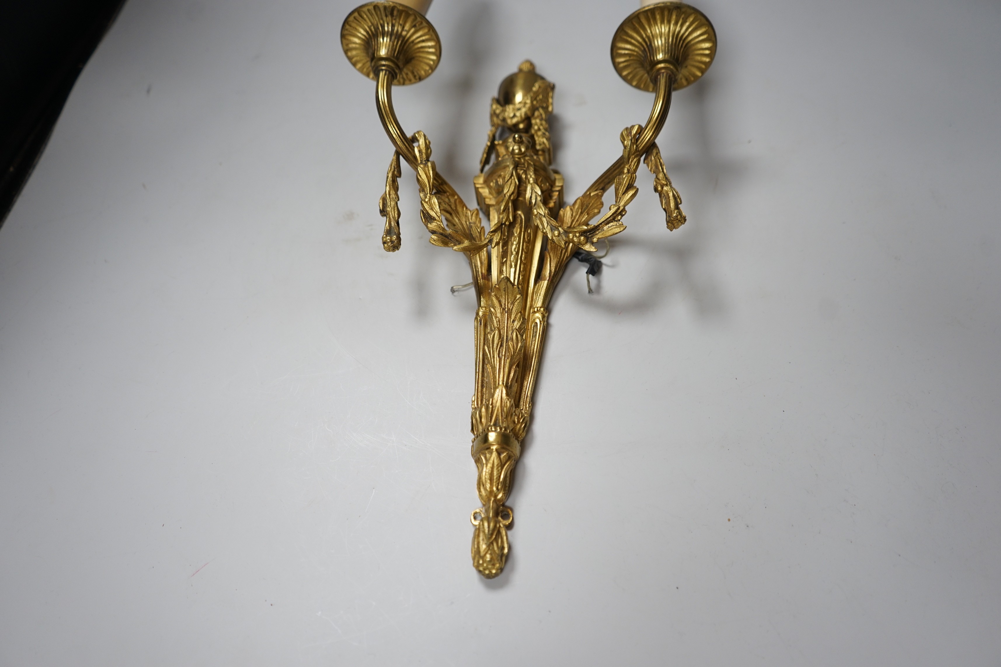 An ornate Louis XVI style gilt metal two branch wall sconce, 48 cm high including bulbs